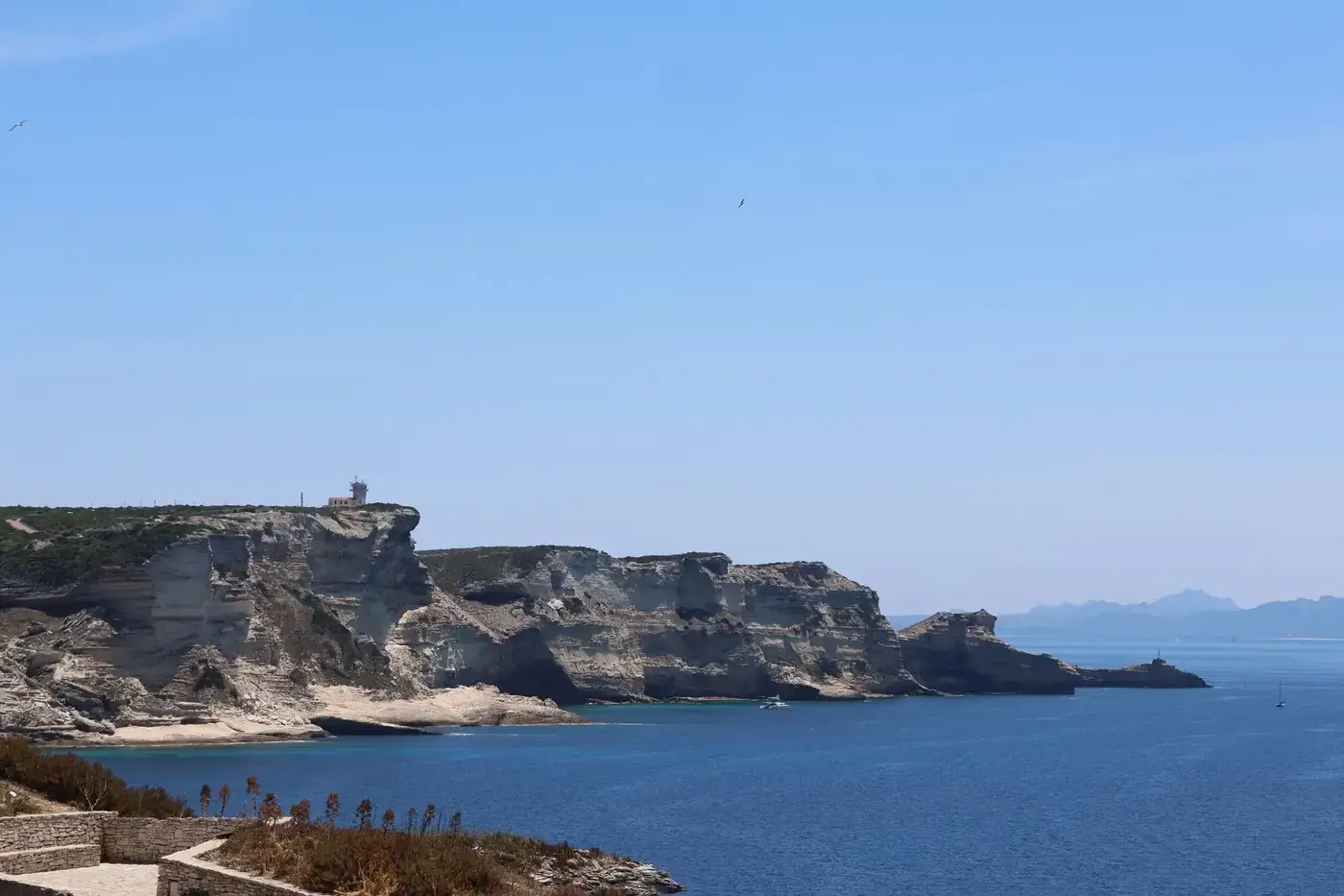 Beautiful coastal cliffs of Bonifacio, Corsica with stunning blue waters and clear skies.