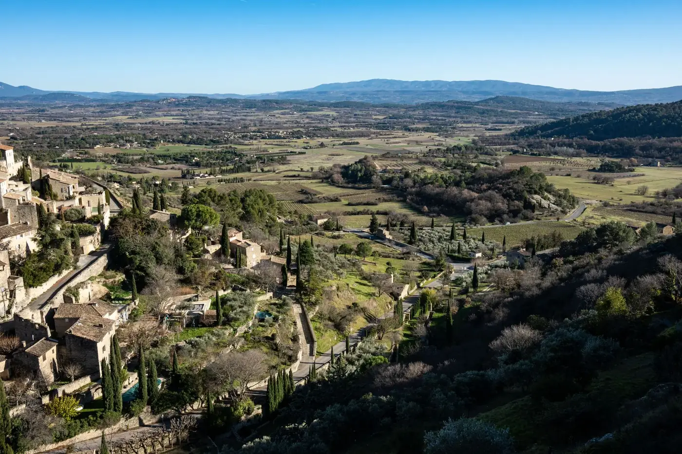 Aerial view of Gordes, a beautiful village in Provence, France with lush landscapes and historic architecture.