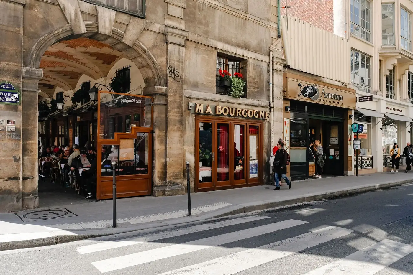 A lively Paris street scene featuring a classic cafe and pedestrians enjoying the day.
