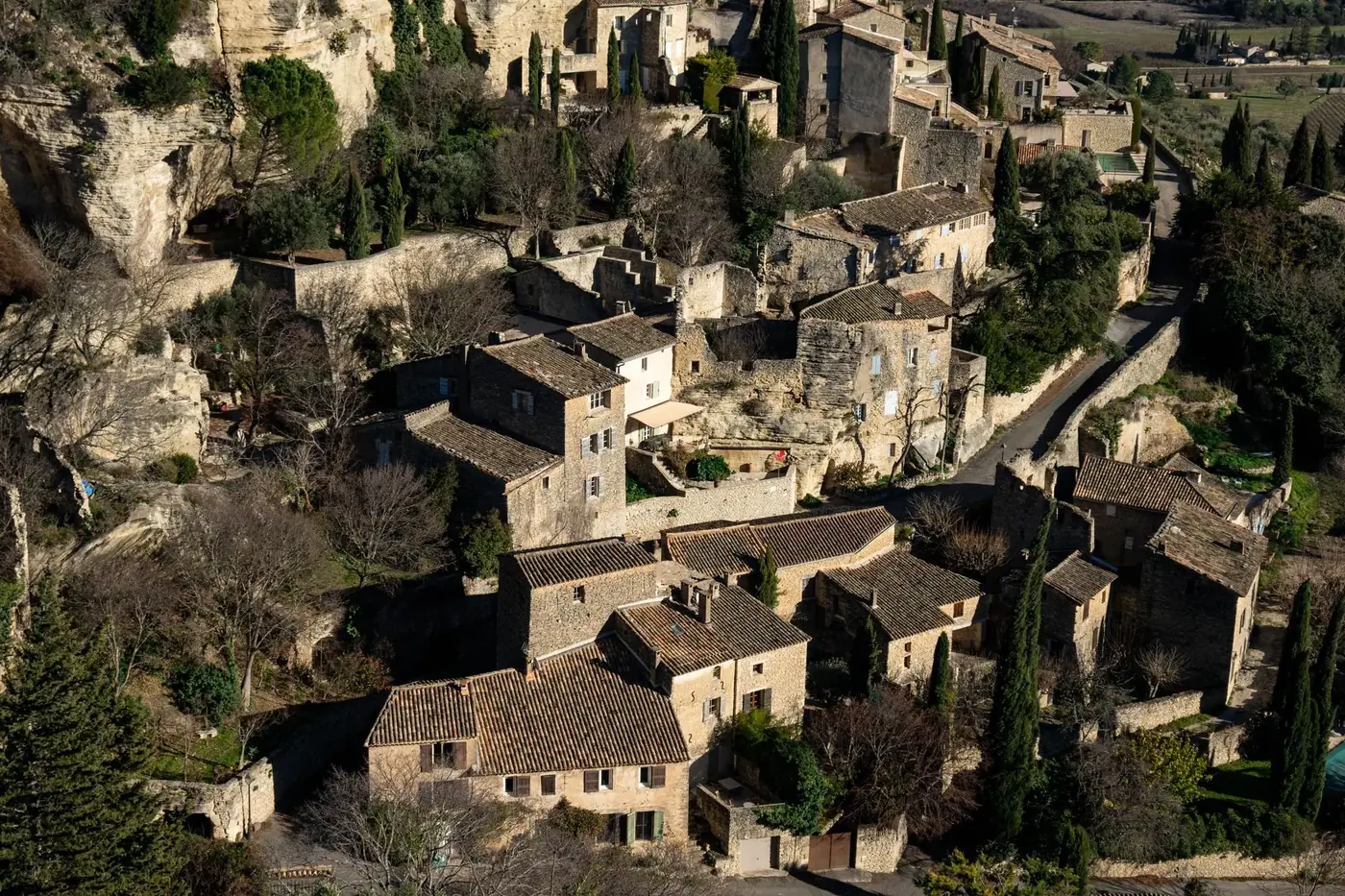 Explore the picturesque village of Gordes, a historic gem in Provence with rustic stone houses and lush greenery.