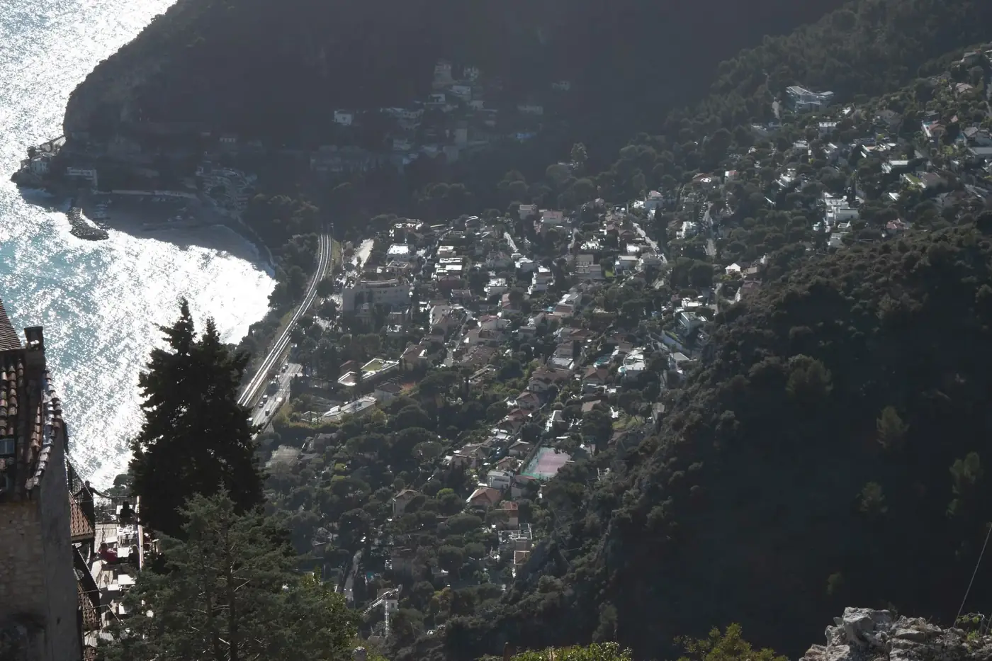 A captivating aerial view of a coastal town in Nice, France, surrounded by lush hills.