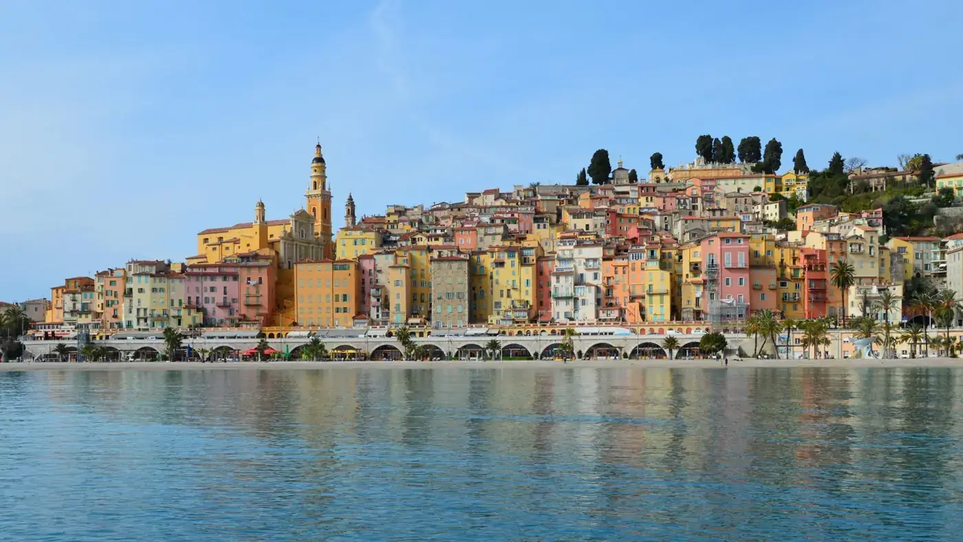 Vibrant townscape of Menton with colorful buildings along the sparkling coast of the French Riviera.