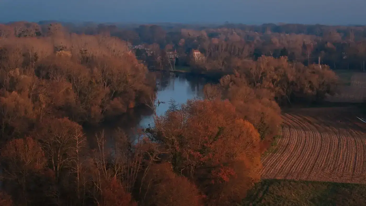 Beautiful aerial view of an autumn landscape near Strasbourg, France, with colorful trees and a river.