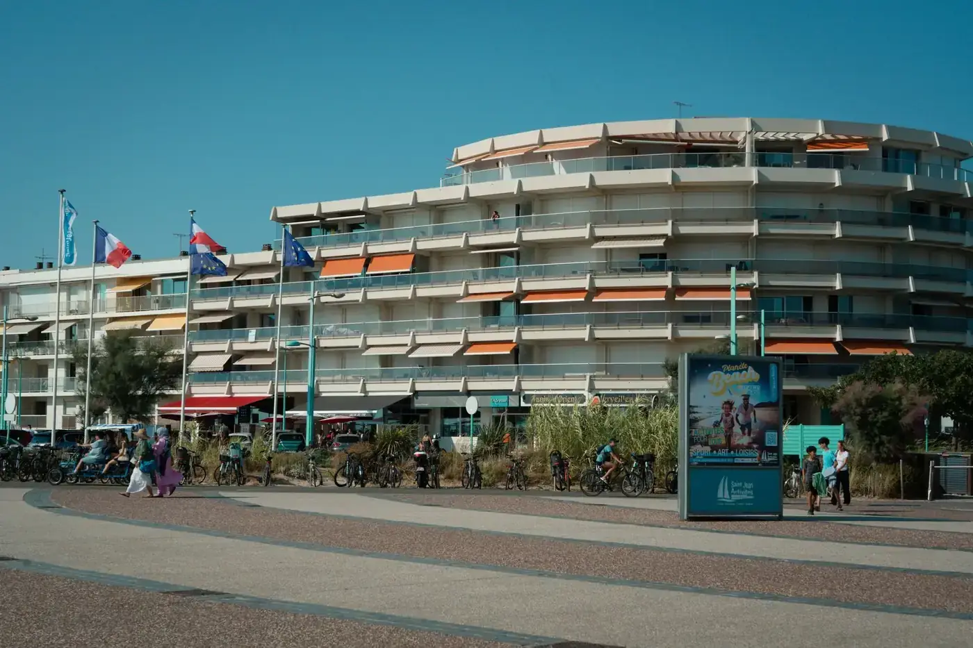 A sunny day at the seafront of Saint-Jean-de-Monts, featuring modern architecture and people enjoying the outdoors.