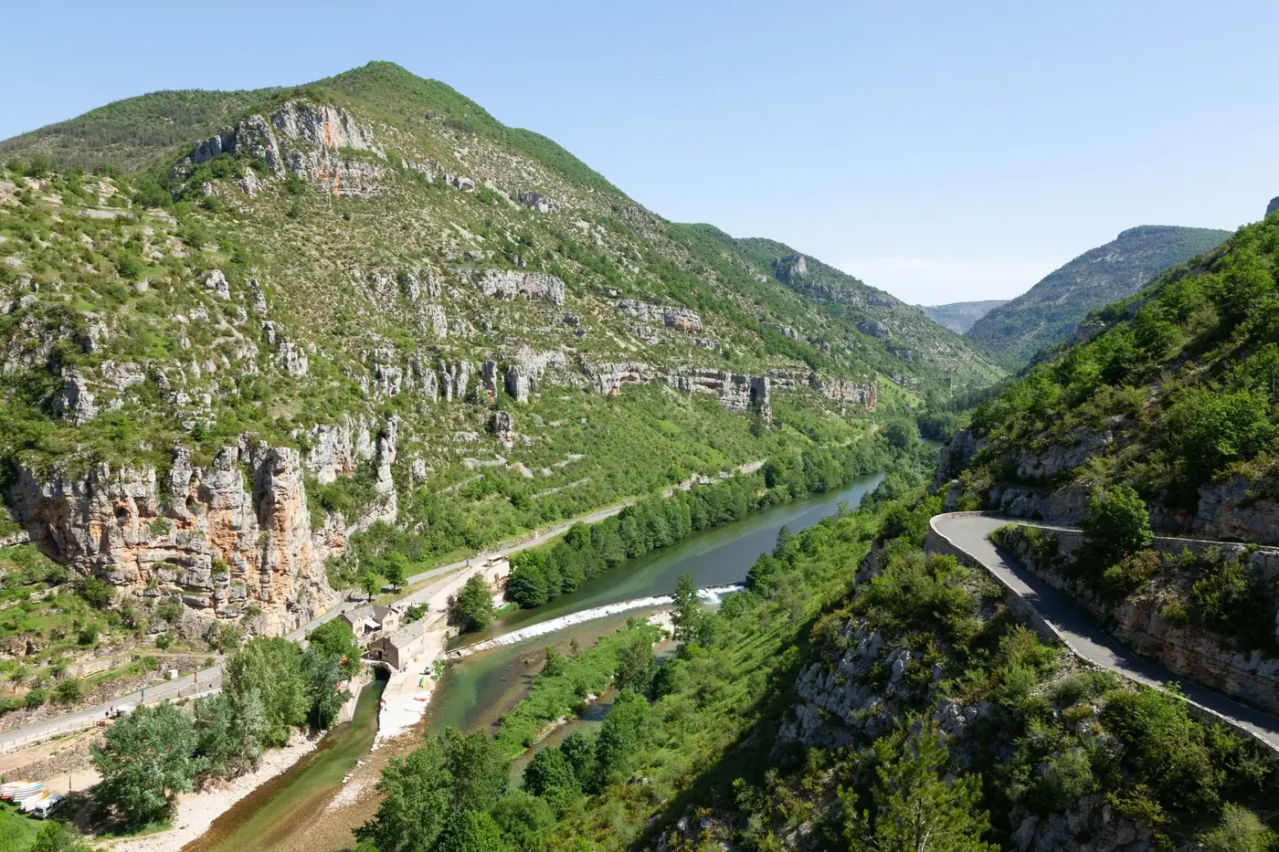 A stunning aerial view of the Gorges du Tarn with winding roads and lush greenery.