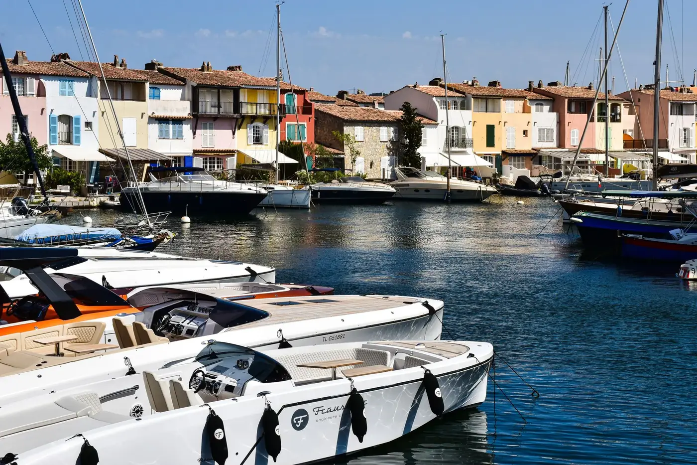 Picturesque canal scene with boats and pastel buildings in the French Riviera.
