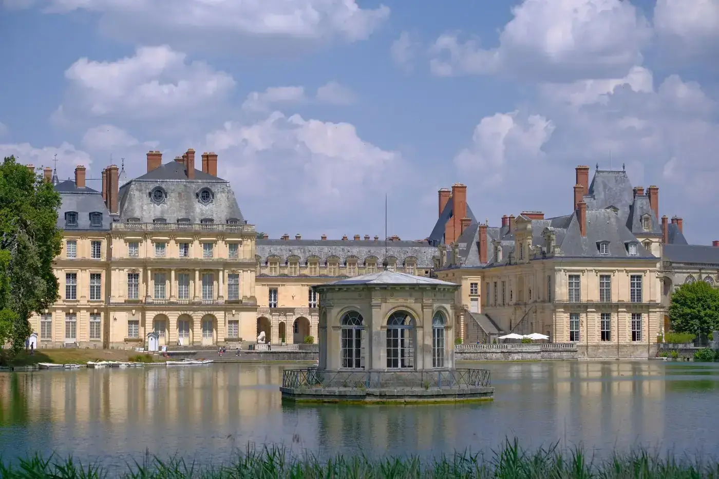 Architectural beauty of Château de Fontainebleau, France, mirrored in its serene lake.