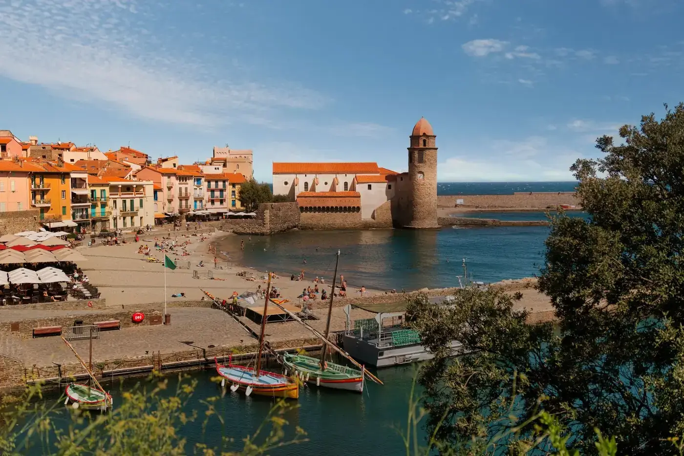 Explore Collioure, France's Mediterranean charm with vibrant architecture and a historic waterfront church.