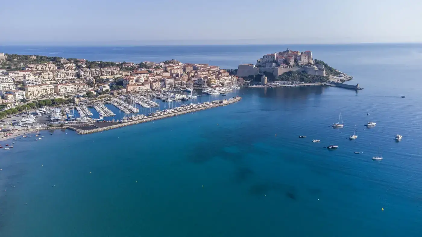 Stunning aerial view of Calvi's marina and citadel, surrounded by the Mediterranean Sea in Corsica.
