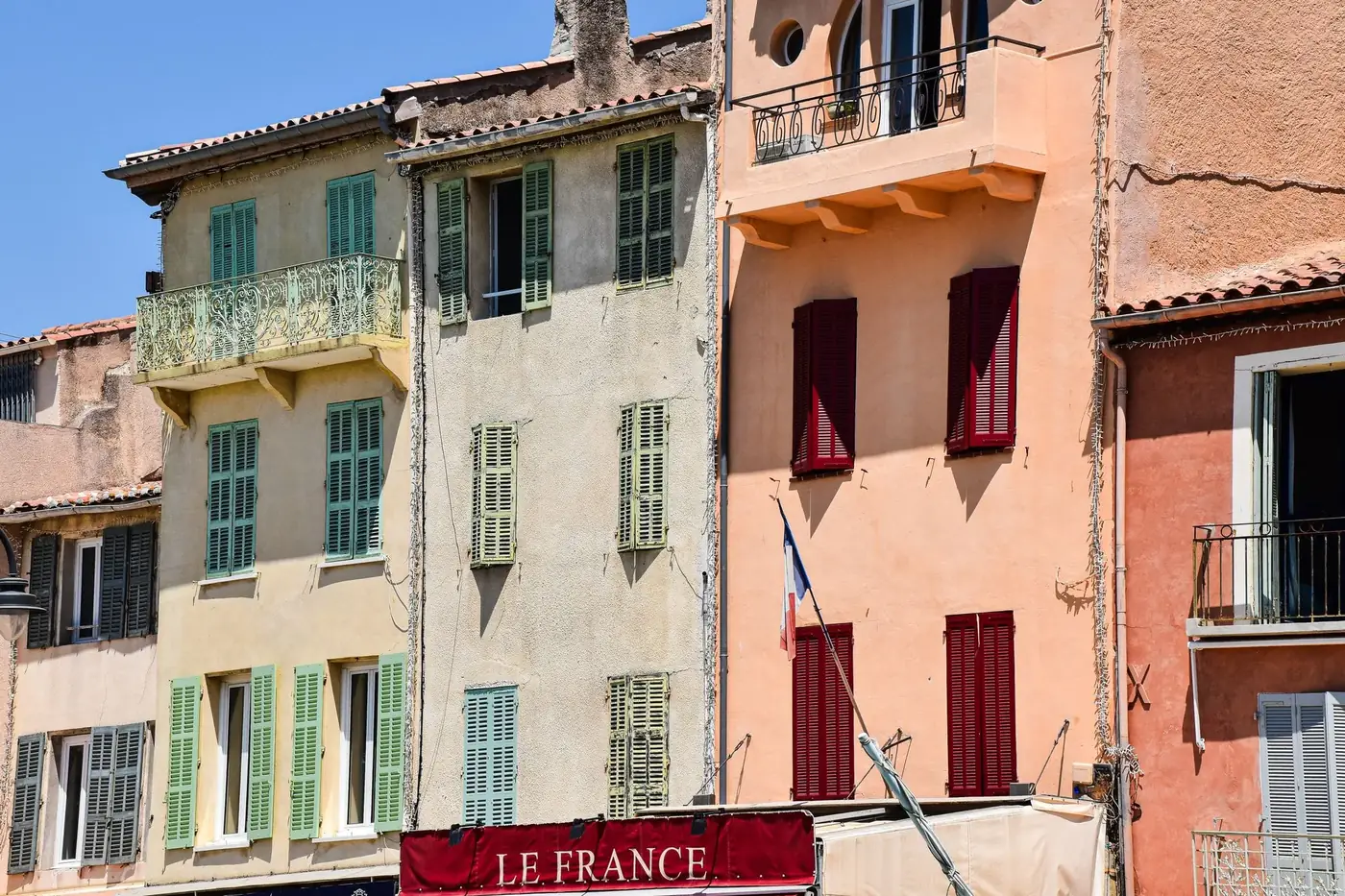Colorful buildings with traditional shutters in Cassis, France.