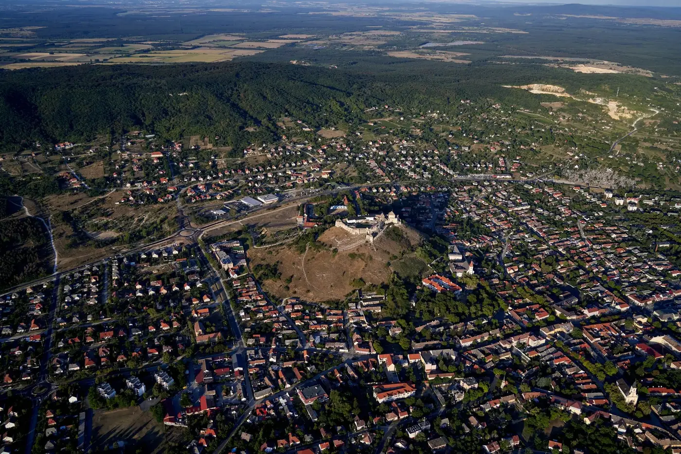Stunning aerial view of Sümeg Castle and residential areas in Hungary during daylight.