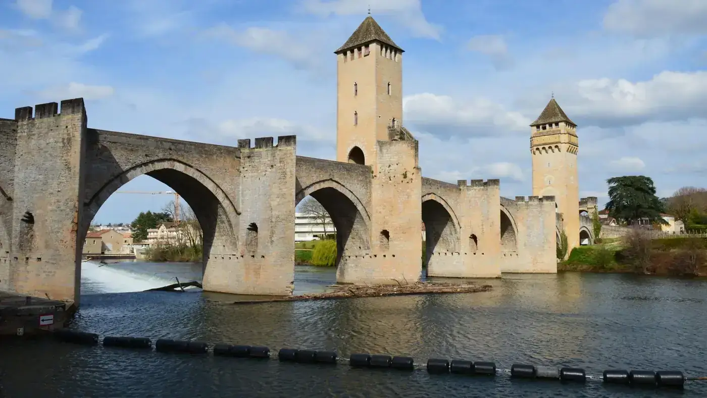 Explore Pont Valentré, a stunning medieval bridge in Cahors, with its iconic towers and river view.