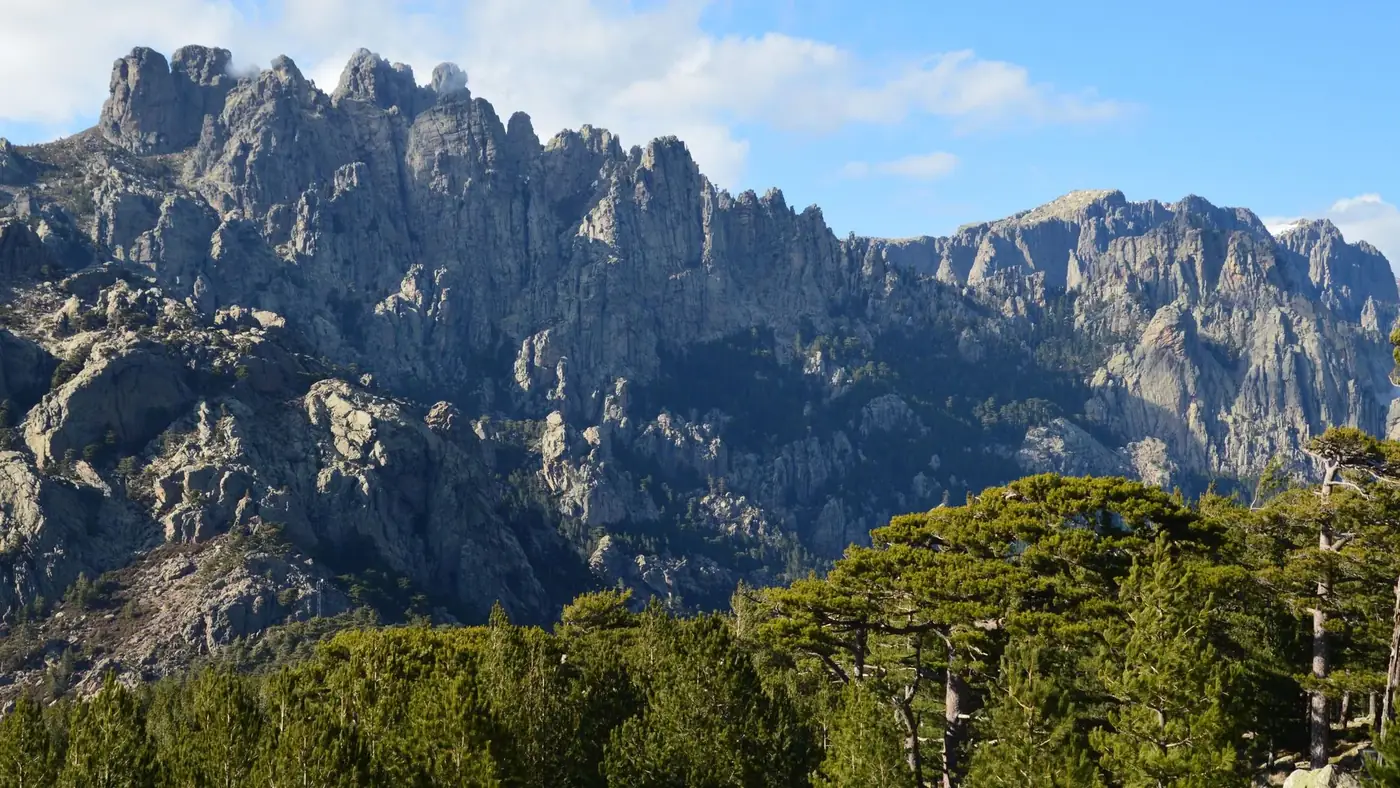 Majestic mountain range with lush greenery in Zonza, Corse, France.