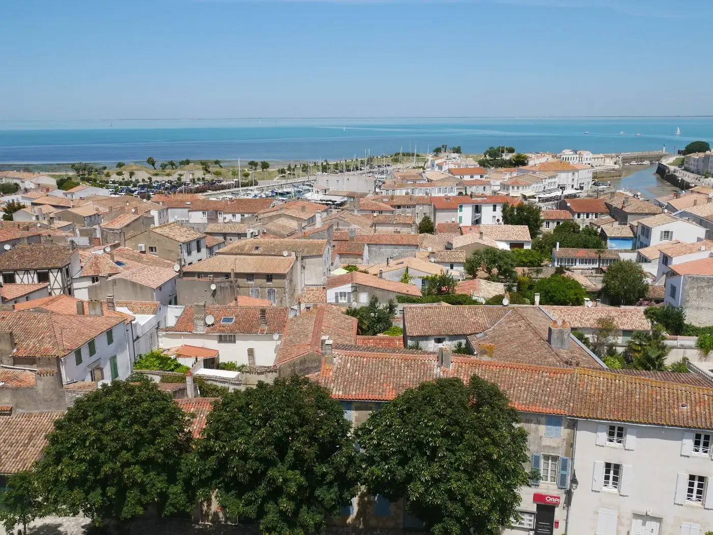 Panoramic aerial view of traditional architecture in Saint-Martin-de-Ré with the scenic coastline in France.